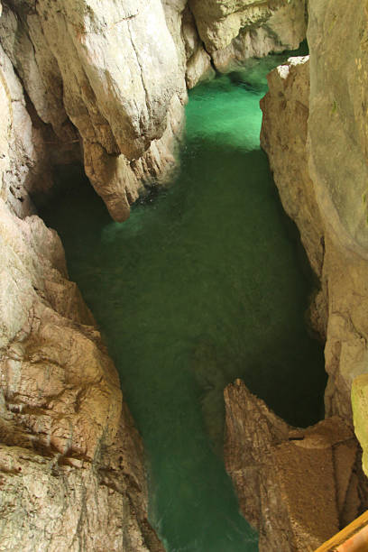 Lake with crystal clear water inside the mountain carved out by a stream. Mis Lake in Veneto, Italy.