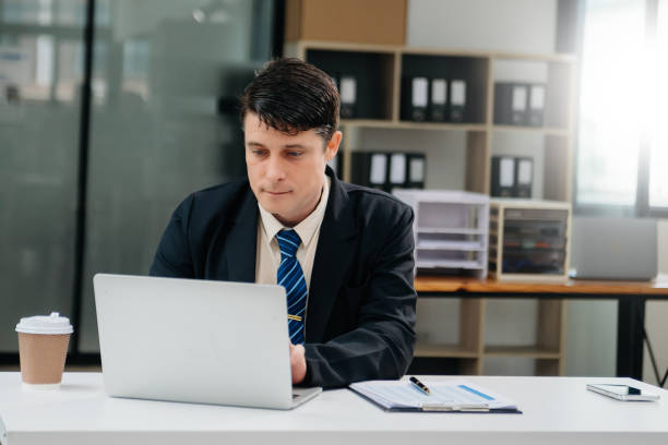 istock Mature business man executive manager looking at laptop watching online webinar training or having virtual meeting video conference doing market research working 2151385505