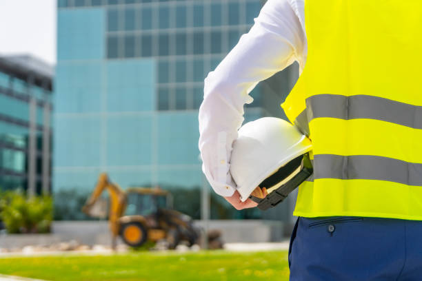 istock Rear view of architect holding a helmet observing remodeling works 2151387339