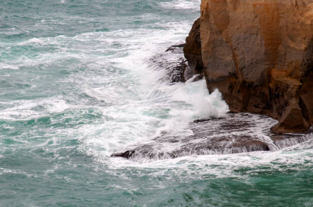 istock Waves breaking around the base of a an rock pillar 2151387527