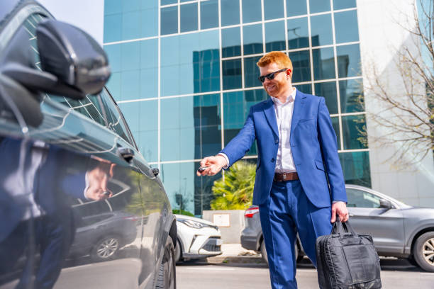 istock Businessman opening the car with a remote control 2151389003