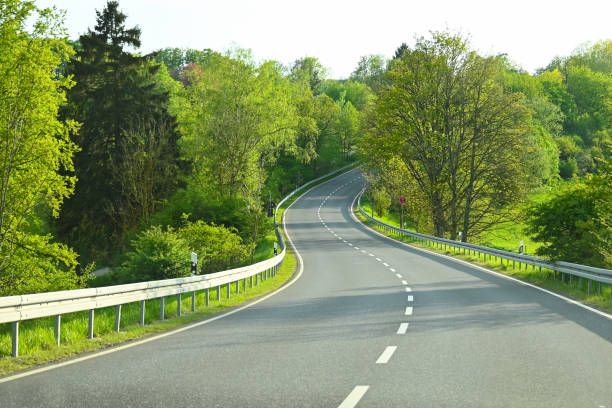 istock car-free highway and abundant vegetation around 2151389963