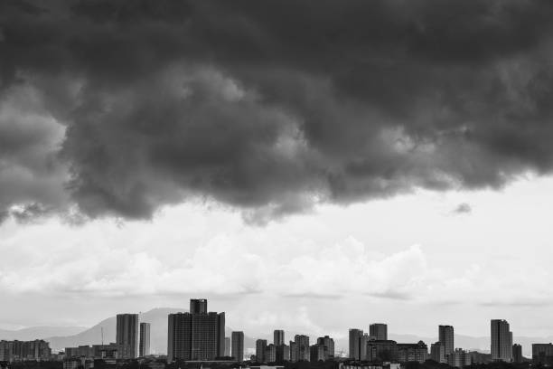 Dark clouds over the city. Black and white.