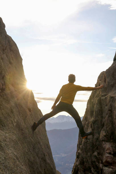 Man climbs gap in cliff face
