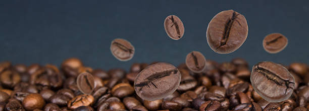 istock Falling coffee beans. Flying defocused coffee beans. Used for cafe advertising, packaging, menu design. Banner. 2151396201