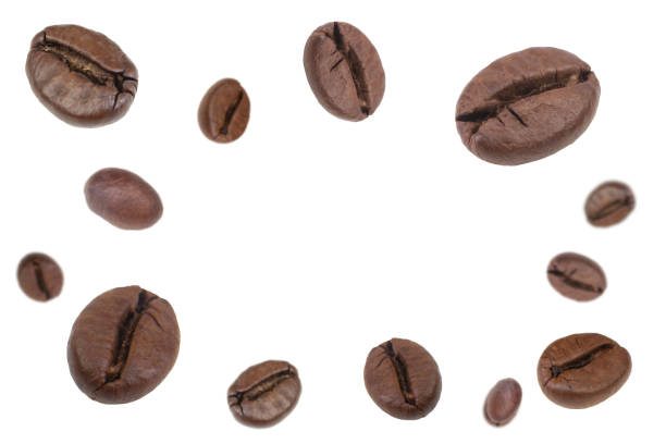 istock Falling coffee beans isolated on white background. Flying defocused coffee beans. Applicable for cafe advertising, packaging, menu design. 2151396423