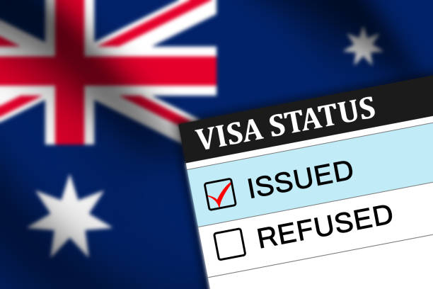 istock Visa status showing issued with Australia flag waving in the backdrop. Austrlia visa issued background concept 2151396687