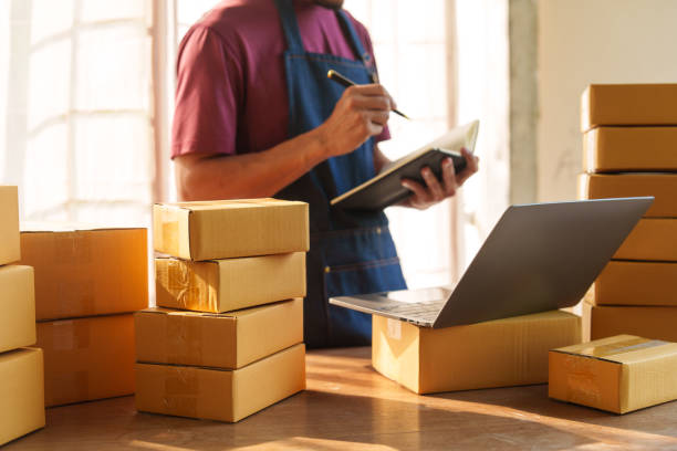 istock Thriving small businesses, often run by male freelancers, entrepreneurs, leverage e-commerce and logistics for online orders. home offices, manage packaging, shipping, client relations using laptops. 2151398842