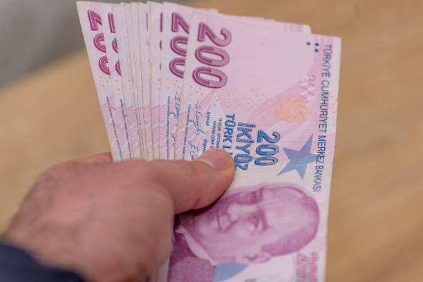 istock paper money held out by a human hand 2151400382
