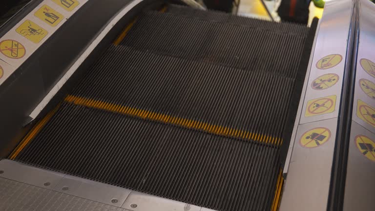 Close-up of escalator in shopping mall. Moving Down Stairs.