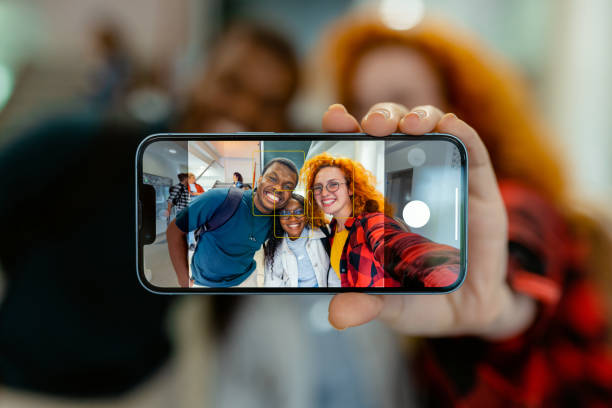 istock Close Up Phone in Female Hand Making Self Portrait at University 2151403399