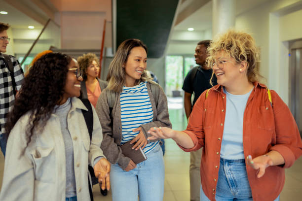 istock Smiling Diverse College Students in School Corridor Talking After Lecture 2151403400
