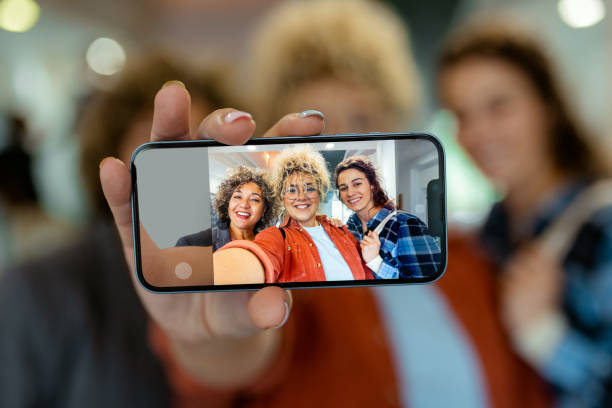 istock Close Up Phone in Female Hand Making Self Portrait at University 2151403530