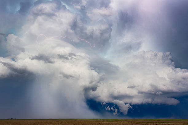 istock Powerful storm cloud downburst with lightning crossing the sky 2151404755
