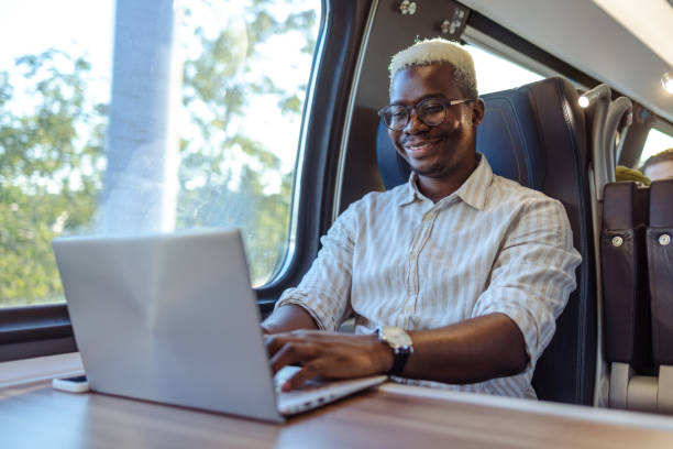 istock African American businessman working on laptop at the train 2151405426