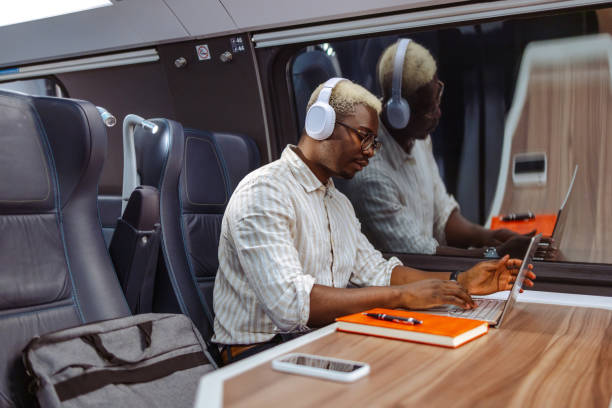 istock African American businessman using laptop at the train at night 2151405823