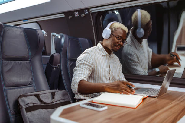 istock African American businessman using laptop at the train at night 2151405963