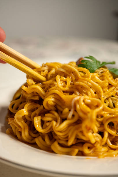 istock cooking instant noodle on metal plate 2151408575