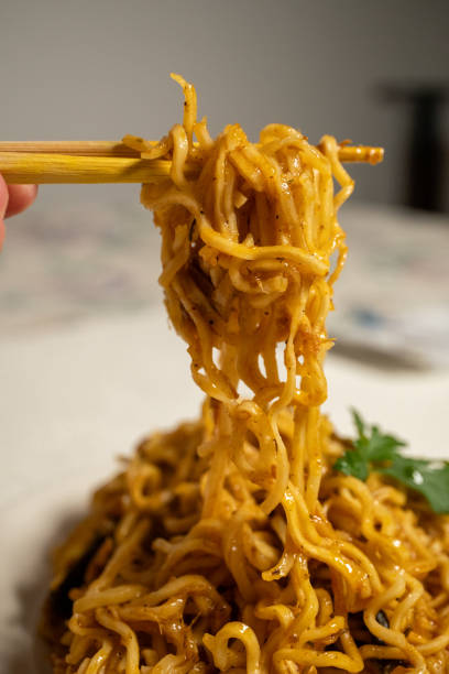 istock cooking instant noodle on metal plate 2151408586