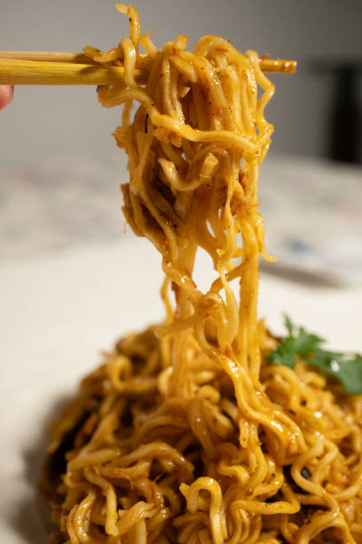 istock cooking instant noodle on metal plate 2151408591
