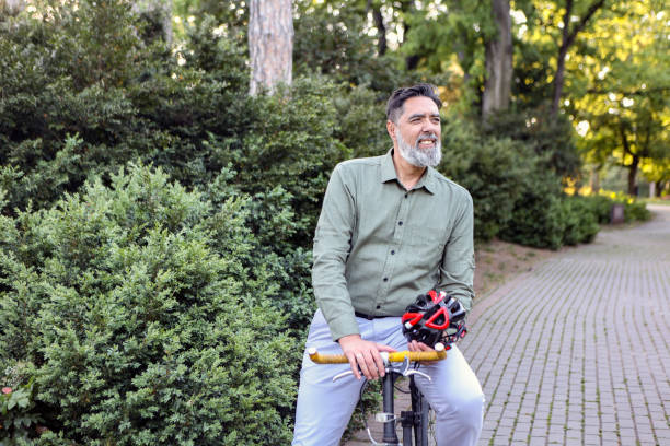 istock Man riding a bicycle in a park 2151418816