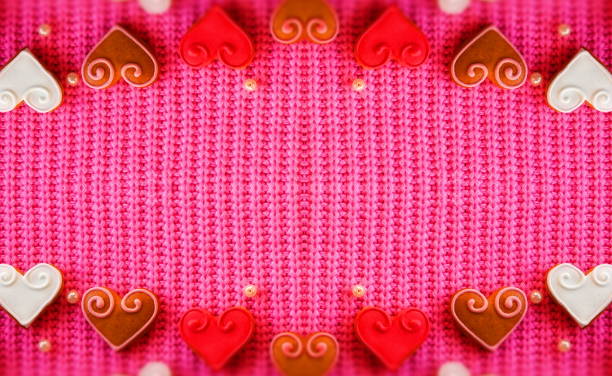 Abstract Creative background for Valentine's day. Red Hearts on a Pink Background. Symmetrical Composition