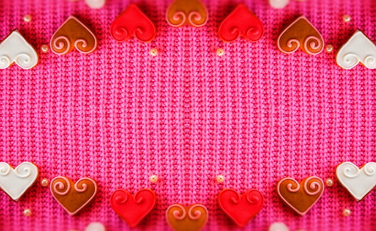 Abstract Creative background for Valentine's day. Red Hearts on a Pink Background. Symmetrical Composition. Web Banner