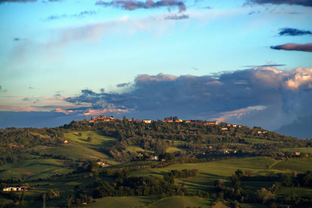 Spring hilly landscape of Montefeltro against scenic cloudy sky