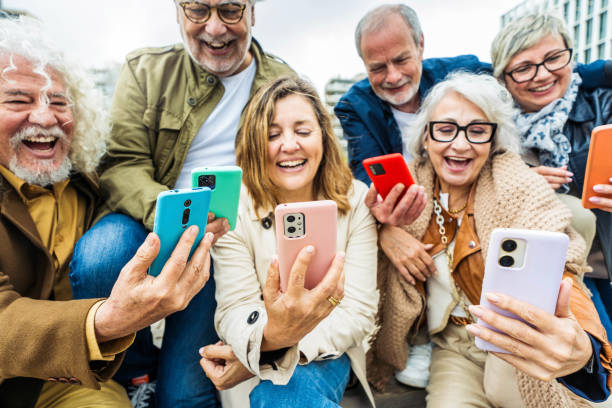 istock Group of senior people using technology devices together - Happy older friends having fun watching funny video on smartphone - Tech and modern elderly concept 2151423976