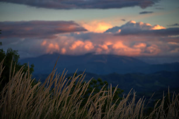 Hilly spring landscape of Montefeltro against cloudy sky at sunset