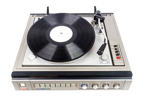 Vintage turntable record player with black vinyl isolated on white background.