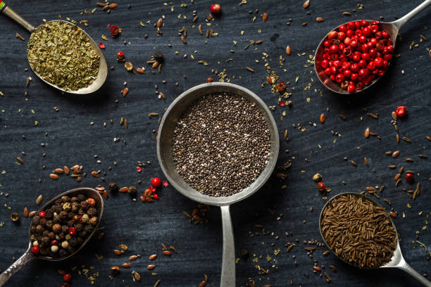 istock Old spoons with various seeds and spices on black background 2151428089