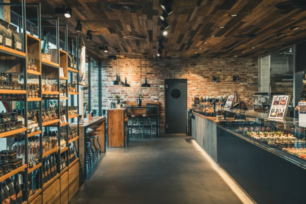 view of a modern bakery with shop and cafe, industrial style with brick wall, wood and steel - steen bouwmateriaal fotos stockfoto's en -beelden