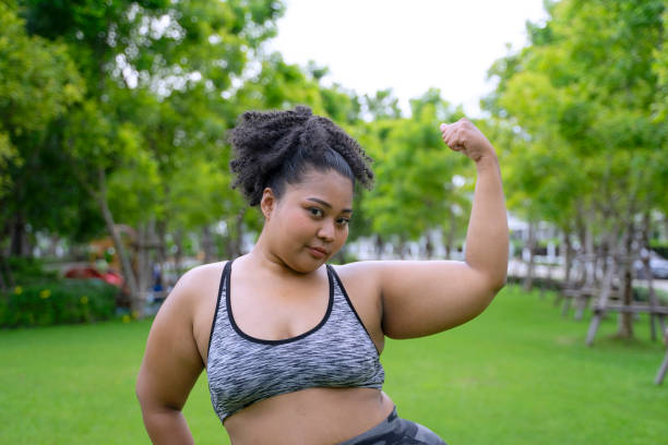 istock chubby woman workout at garden. 2151431478