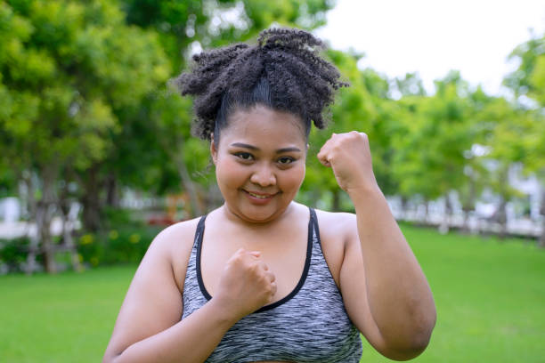 istock chubby woman workout at garden. 2151431563