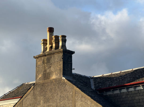 istock Chimney pots in a row on old victorian building roof 2151431620