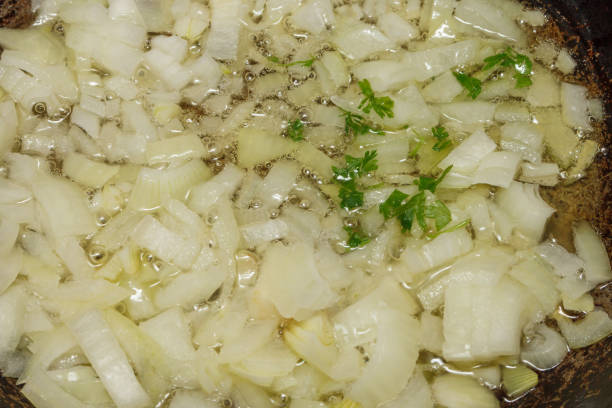 istock Fried onions in oil with herbs. 2151434795