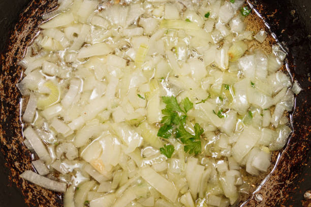 istock Fried onions in oil with herbs. 2151434800