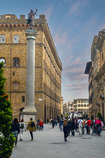 Florence, Tuscany, Italy - 03 30 2024: Piazza Santa Trinita is located next to Via de' Tornabuoni and is characterized by the ancient column 11 meters high.