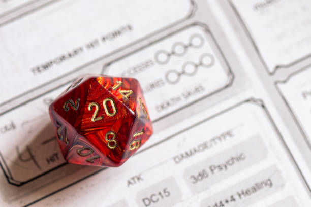 istock Critical Hit: Red D20 Dice on Detailed RPG Character Sheet 2151438798