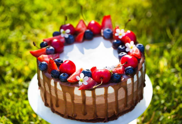 Delicious homemade Three chocolate mousse cake decorated with fresh berries
