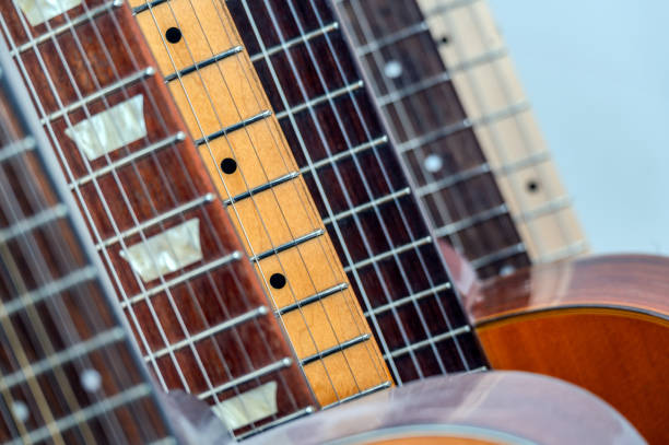 Close-up of several guitar necks lined up