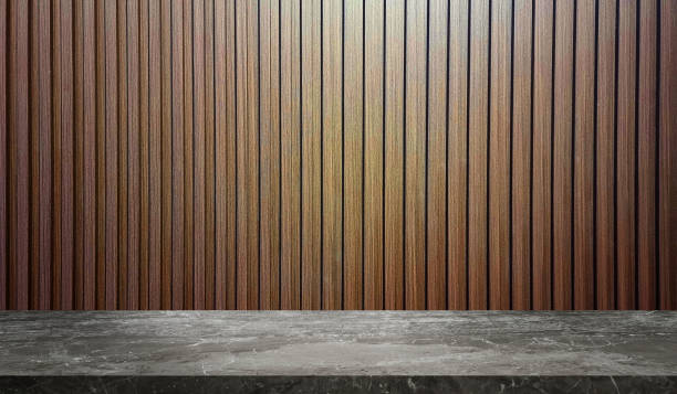 istock grey marble table in front of vertical walnut wooden slats background with light from above for product displayed. stone table with wooden in striped line pattern backdrop. 2151445271