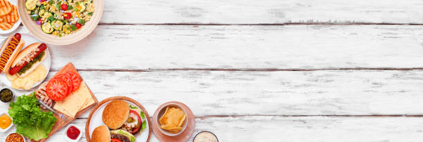 istock Summer BBQ or picnic corner border over a white wood banner background 2151445796