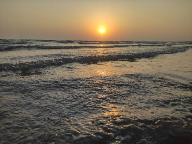 istock The image captures a serene beach scene at sunset. 2151449943