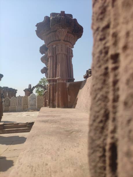 istock The image displays a detailed stone column against a clear blue sky. 2151450116