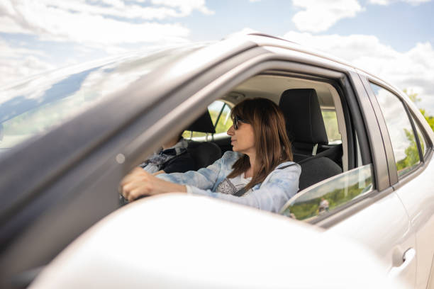 istock Female friends going on a road trip in a car. 2151451465