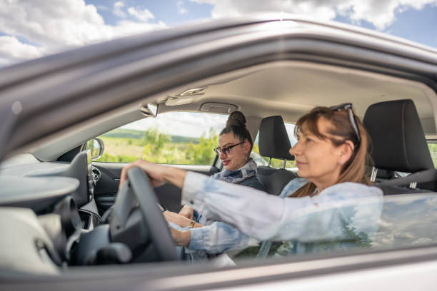 istock Female friends going on a road trip in a car. 2151451528