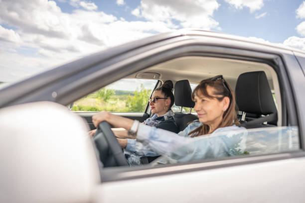 istock Female friends going on a road trip in a car. 2151451697