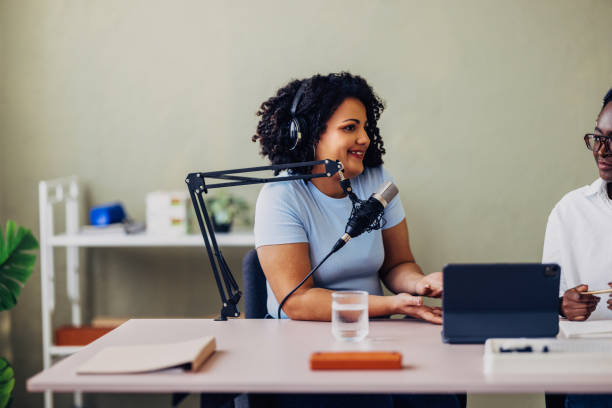 istock Female Podcaster Discussing with Guest in Studio 2151451892